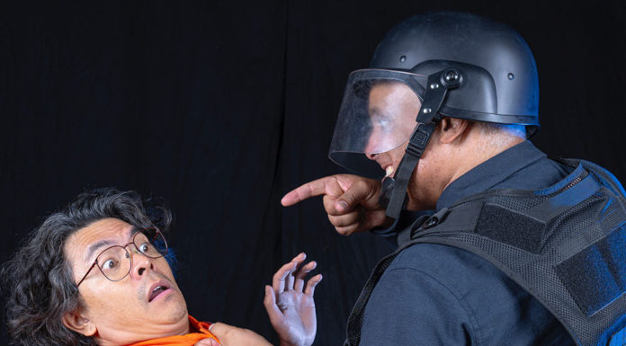 SF Mime Troupe to perform in Santa Cruz Two performers acting as prisoner and guard