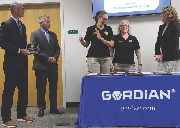 Santa Cruz County Sheriff's forensic team members receive an award for their new $1.8 million DNA lab.