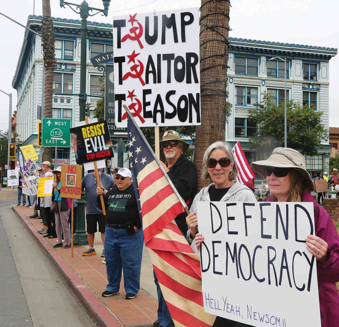 People line main street in Watsonville Saturday to protest President Trump's policies.
