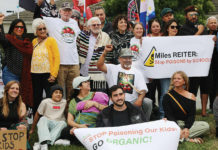 About 50 people gather in front of Driscoll’s headquarters on Westridge Drive in Watsonville to protest pesticide use in area agricultural fields.