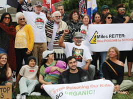 About 50 people gather in front of Driscoll’s headquarters on Westridge Drive in Watsonville to protest pesticide use in area agricultural fields.